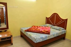a bedroom with a bed with a dresser and a mirror at Munnar Valley View in Munnar