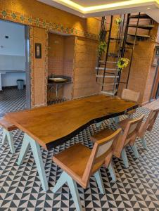 a wooden table and chairs in a room at Aura Kabini by Tripture in Begūr