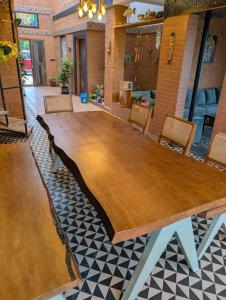 a large wooden table in a room with chairs at Aura Kabini by Tripture in Begūr +11 photos
