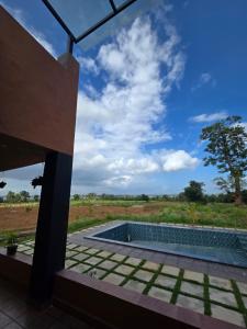 a view of a pool from a house at Aura Kabini by Tripture in Begūr