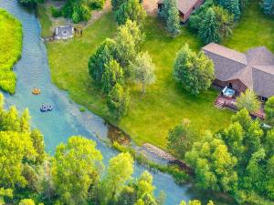 an aerial view of a house and a river at Private Island Fire Pit & Arcade in Rigby