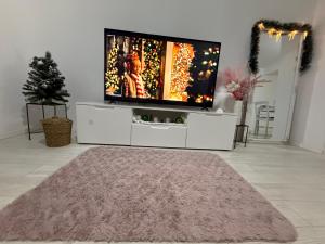 a living room with a television on a white cabinet at Lucija,Vila Vuletic in Neum