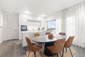 a kitchen and dining room with a table and chairs at Unbeatable Central Location - Reykjavíks Most Exclusive Luxury Apartments in Reykjavík