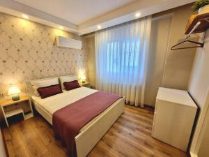 a bedroom with a large bed and a window at 2 Bedroom Cozy Apartment in Antalya