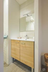 a bathroom with a sink and a mirror at Résidence La Mayt in Vars +101 photos