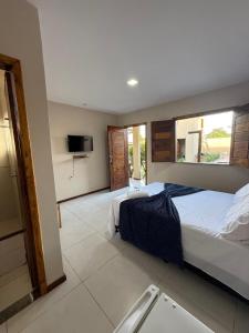 a bedroom with a bed and a television in it at Pousada Encantos do Litoral in Marau +23 photos