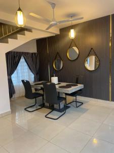 a dining room with a table and chairs and mirrors at Noahjoelestate in Accra