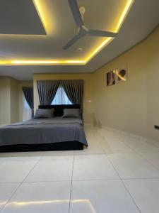 a bedroom with a bed with a ceiling fan at Noahjoelestate in Accra