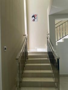 a hallway with stairs with a picture on the wall at Noahjoelestate in Accra