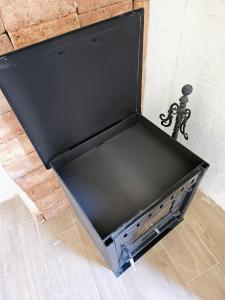 a black box sitting on the floor next to a brick wall at La Mocha Casa Rural - La Casa de María in La Iruela