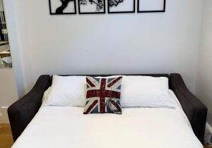 a bed with two pillows on top of it at Talbot Lane Cottage Horsham By My Getaways in Horsham