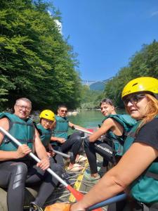 a group of people are rafting on a river at Camp Apartmani Tara in Pljevlja +5 photos