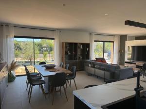 un soggiorno con un tavolo e un divano di Casa Nostra Villa Récente Climatisée - Piscine Chauffée a Lecci