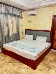 un dormitorio con una cama en una habitación en Essérè Mabia hôtel E-M, en Brazzaville
