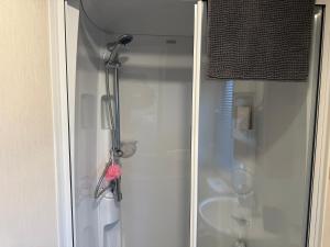 a shower in a bathroom with a glass door at Riverside Haven in Crowle +112 photos