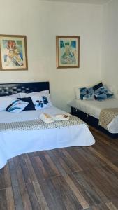 two beds sitting in a room with at Hostel Suite Home in Saquarema