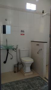 a bathroom with a toilet and a sink at Hostel Suite Home in Saquarema +20 photos