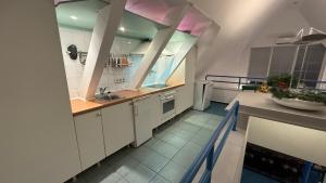 a large kitchen with white cabinets and a sink at Elbträume Lodge in Ellerhoop +3 photos