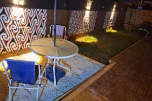 a table and two chairs in a yard at night at El KINTU WASI in Vicuña +18 photos
