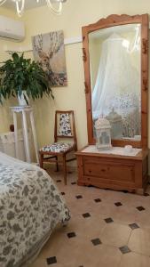 a bedroom with a mirror and a bed and a chair at Flor de Loto in Candeleda