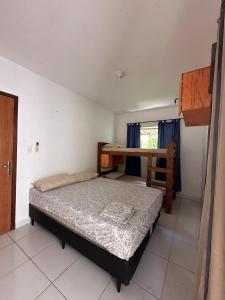 a bedroom with a bunk bed and a desk at Pipa Guest House in Pipa