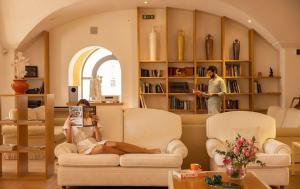 a woman laying on a couch in a living room at Tenuta Moreno in Mesagne
