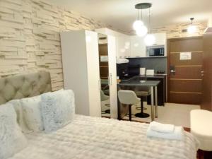 a bedroom with a bed and a kitchen with a table at Luxury studio Perun Lodge in Bansko