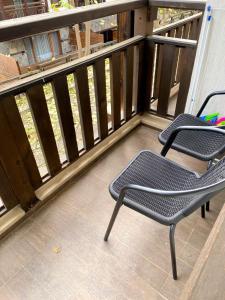 two chairs sitting on the balcony of a house at Luxury studio Perun Lodge in Bansko