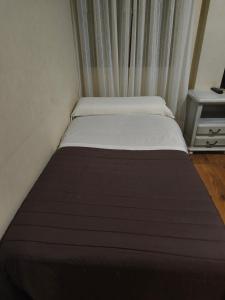 Una cama o camas en una habitación de Hostal Tic-Tac