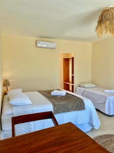 Ένα ή περισσότερα κρεβάτια σε δωμάτιο στο Ventuh Tatajuba