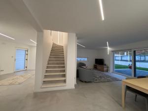 a living room with a staircase in a house at Le Cube Strasbourg - Marlenheim in Marlenheim