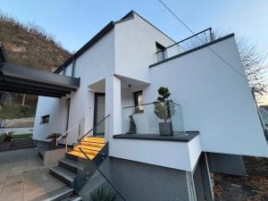 a white house with stairs and a balcony at Le Cube Strasbourg - Marlenheim in Marlenheim