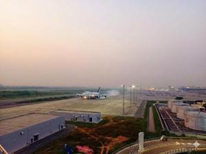 an airplane is on the runway at an airport at Best Eastern Apartments - With Balcony & Kitchen in Dhaka