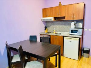 a small kitchen with a wooden table and a table and chairs at Predela 1 - Studio 10 near Bansko Ski Lift in Bansko +54 photos