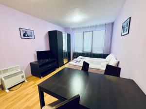 a living room with a table and a couch at Predela 1 - Studio 10 near Bansko Ski Lift in Bansko