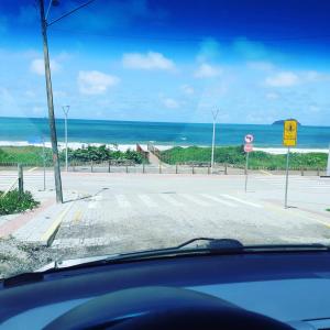 a view from a car of a road with the beach at Casa Praia in Piçarras +1 photo