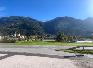a stop sign on a road with mountains in the background at Apartament Luna Stams in Stams