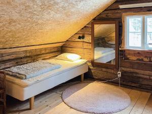 una camera da letto con un letto e uno specchio in una stanza di 5 person holiday home in ÅSEDA a Åseda