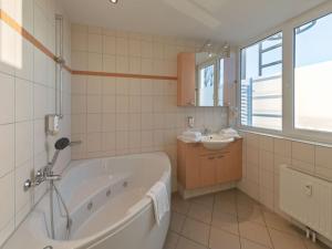 a white bathroom with a tub and a sink at elegant eingerichtete Ferienwohnung in Granzow +29 photos
