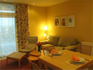 a living room with a couch and a table at elegant eingerichtete Ferienwohnung in Granzow +26 photos