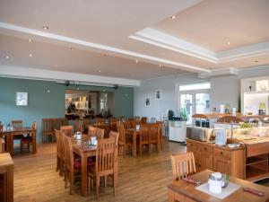a dining room with wooden tables and chairs at elegant eingerichtete Ferienwohnung in Granzow