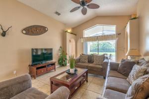 a living room with couches and a flat screen tv at Safari Lodge in Orlando