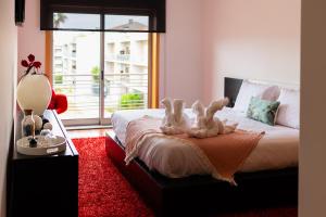 Ένα ή περισσότερα κρεβάτια σε δωμάτιο στο Fão Apart Vacation Apartments +37 φωτογραφίες