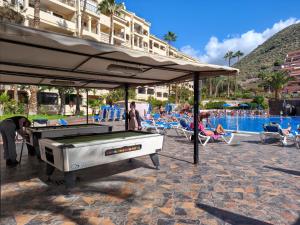 a pool table under an umbrella at a resort at Dreams Castle in Los Cristianos