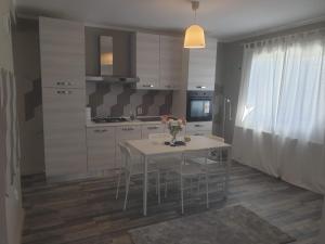 a kitchen with a table and chairs in a room at MCD Apartment Central in Craiova