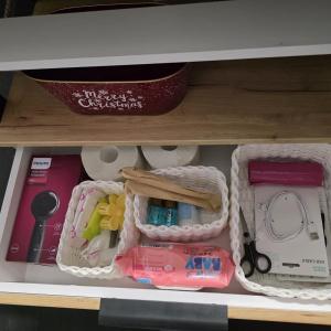 a drawer filled with various items on a shelf at Olive Ultracentral Craiova in Craiova