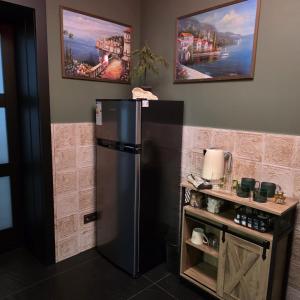a black refrigerator in a kitchen with a counter at Olive Ultracentral Craiova in Craiova