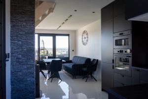 a kitchen and dining room with a table and chairs at Black barn in Rusinowo