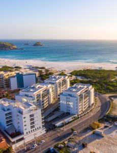 an aerial view of a beach with white buildings at Resort Praia Grande in Arraial do Cabo