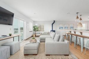 a living room with two couches and a kitchen at Sunset Shores in Pacific City